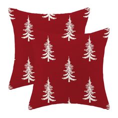 two red pillows with white trees on them