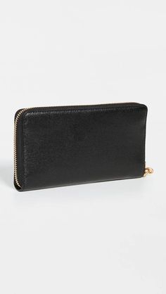 The Robinson Zip Continental Wallet is the perfect everyday companion for your busy lifestyle. Crafted from premium saffiano cowhide leather with a distinctive gold-tone emblem, it offers sleek organization and security with an exposed zipper closure and zipped interior pocket. Card slots, pockets, and an 8oz weight provide sturdy storage and portability to discreetly carry cash, cards, receipts and more. An optional wristlet keeps essentials close at hand. Slip it into a purse, bag or jacket po Elegant Bifold Wallet With Zipper Pocket, Leather Evening Wallet With Zipper Closure, Elegant Leather Wallet With Zipper Closure, Classic Formal Wallet With Zipper Closure, Leather Bifold Clutch With Zipper Closure, Formal Clutch Wallet With Zipper Closure, Classic Clutch Wallet With Zipper Closure, Classic Formal Clutch With Zipper Closure, Tory Burch Robinson