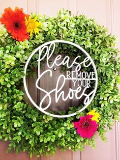 a wreath that says please remove your shoes