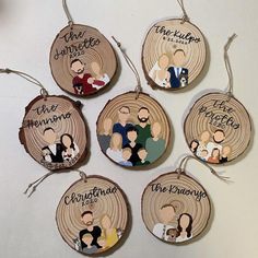 six personalized wood slices with the names of people hanging from each ornament