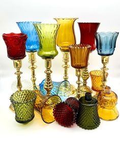 many different colored glass vases sitting next to each other