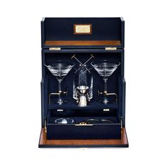 three martini glasses in a black case with gold trimmings on the bottom and sides