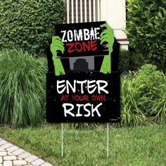 a sign that says zombie zone enter at your own risk on the grass in front of some bushes