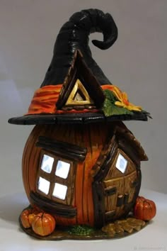 a pumpkin shaped house with a witches hat on top