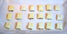 small sandwiches are arranged on a baking sheet