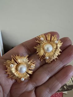 The Victorian studs are handcrafted in brass and gold polish with beautiful pearls embedded on a statement gold base. Pick this gorgeous pair and make a stunning statement! Shine away at your next special event The diameter is 3 inches approximately. Push back closure. Gold Studded Earrings, Chic Gold Clip-on Earrings With Pearl Drop, Formal Gold Pearl Embellished Earrings, Glamorous Gold Pearl Earrings For Formal Occasions, Metal Pearl Earrings For Wedding, Metal Pearl Earrings With Plating For Wedding, Gold Clip-on Pearl Earrings, Wedding Pearl Earrings With Metal Plating, Chic Gold Pearl Earrings For Party