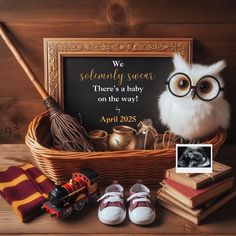 a harry potter themed baby shower with an owl in the basket next to it and other items