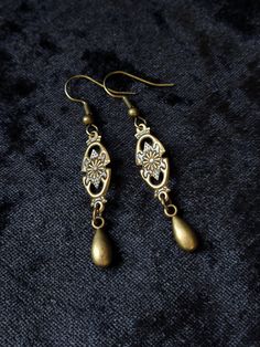 "These earrings are small and lightweight but very elegant and ladylike. If you want to add a little Victorian flair to your image without much commitment, this pair is a good find. MEASUREMENTS: The earrings are 5/16\" (0.8 cm) wide. Total length will depend on the earwires of your choice. With hooks - 2 1/16\" (5.2 cm) long; Lever backs - 1 15/16\" (4.9 cm) long; Studs and clip-ons - 1 11/16\" (4.3 cm) long Available with your choice of ear wires (select at checkout). See all the options in th Nickel Free Teardrop Metal Flower Earrings, Nickel-free Metal Teardrop Flower Earrings, Vintage Gold Teardrop Flower Earrings, Gold Vintage Teardrop Flower Earrings, Formal Drop Metal Earrings, Silver Elegant Flower Earrings In Brass, Elegant Silver Flower Earrings In Brass, Bronze Pierced Earrings For Formal Occasions, Formal Bronze Pierced Earrings