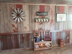 a room with wooden walls and red paint on the walls is decorated with windmills