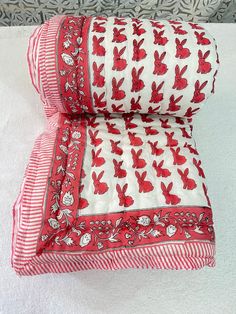 two red and white pillows sitting on top of each other