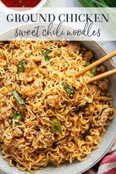 a bowl full of ground chicken and noodles with chopsticks in the bowl next to it