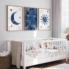 a baby's room with two posters on the wall