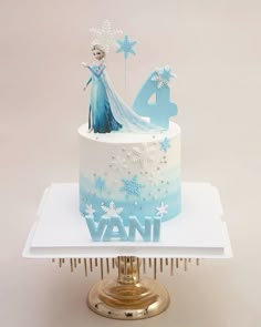 a frozen princess cake with frosting and stars on the top is sitting on a plate