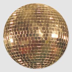 a shiny gold disco ball on a white background