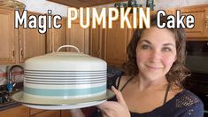 a woman holding up a cake on top of a plate in a kitchen with the words magic pumpkin cake