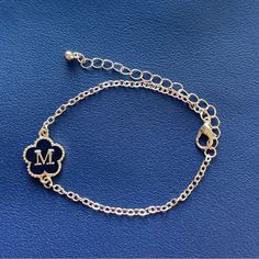 Black Flower, Initial Letter M Chain Bracelet Plated Zinc Alloy Hand Chain Jewelry Personalized Bracelet Trendy Personalized Clover Bracelet Letter: M Plating: 18k Gold Plated Main Material: Zinc Alloy It Comes With Extension Chain Trendy Silver Flower Bracelets, Black Bracelet Jewelry For Mother's Day, Black Flower Bracelets For Gifts, Black Charm Bracelet With Adjustable Chain, Personalized Black Metal Charm Bracelet, Flower Initial, Hand Chain Jewelry, Bracelet Trendy, M Jewelry