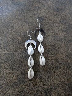 Long silver and cowrie shell earrings.  French hooks. Silver Shell-shaped Bohemian Jewelry, Silver Bohemian Shell Jewelry, Bohemian Silver Shell Jewelry, Bohemian Silver Shell-shaped Jewelry, Silver Teardrop Jewelry For Summer, Adjustable Silver Shell-shaped Earrings, Beach Jewelry With Matching Earrings In Silver, Silver Dangle Earrings For The Beach, Handmade Silver Shell Jewelry