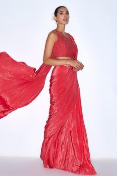 Red pre draped saree featuring cutdana embroidery and attached lining. Paired with a sleeveless padded blouse with a one-shoulder neckline and back hook closure., Fit: Relaxed Party Wear Draped Silk Saree, Party Blouse Piece With Draped Pallu, Red Blouse Piece For Evening With Traditional Drape, Draped Cutdana Choli For Party, Sequined Draped Choli For Diwali, Draped Blouse Piece For Evening Festivals, Festive Draped Silk Choli, Cutdana Draped Choli For Parties, Red Pre-draped Saree For Party