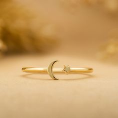 Astrid Just for you, the moon, and the stars. Handcrafted in 14k or 18k solid gold to ensure you never go without them. It is also available in different sizes for the best comfort fit. - Handmade- Solid Gold- Band Thickness: 1.1 mm- Size of the Moon: 4.5 mm- Size of the Star: 2.5 mm All pieces come beautifully boxed in suede pouches you can always use when traveling! Star Minimalist, Gold Cuff Ring, Dream Accessories, Accessories Board, Silver Ring Band, Ring Bands, Moon And Star Ring, Charm Ring, Mini Moon