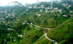 an aerial view of a village on the side of a hill