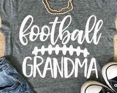 a t - shirt that says football sister with an arrow on the front and two pairs of shoes next to it