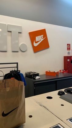 a nike store with an orange and white sign on the wall above it's counter