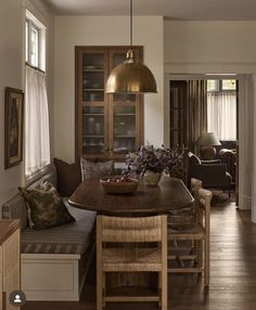 a dining room table with chairs and a bench