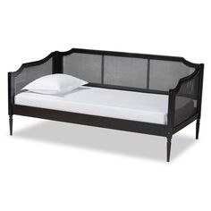 a bed with a black frame and white sheets