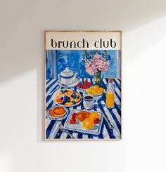 an advertisement for brunch club hangs on the wall above a table with fruit and juice