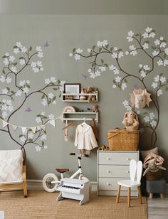 a child's room with a tree mural on the wall