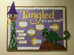 a bulletin board with an image of a green lizard and a purple hat that says tangled up in your schedule