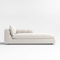 a white couch sitting on top of a white floor