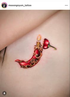 a woman's stomach with a tattoo on it that looks like a red shoe