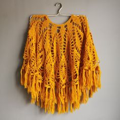 Beautiful Yellow Chrocheted Poncho with brushes. Vintage handmade. Material: woolike yarn. Size: EUR 38-42. Small diameter(neckline): 17 cm / 6.7" Big diameter without brushes: 100 cm / 39" Brushes lenght:~ 10 cm / 4" Handwash only. Cute warm gift for women, mom, grandma and vintage lovers. 💌I combine shipping if you need. Item will be shipped in 1-2 days after payment will be clear. All items are very safe packed. I ship from Latvia with tracking number. Please to add your phone number for the Handmade Bohemian Yarn Poncho, Bohemian Yellow Poncho One Size, Yellow Bohemian Poncho One Size, Yellow Bohemian Poncho For Fall, Yellow Bohemian One Size Poncho, Yellow Bohemian One-size Poncho, Handmade Yarn Poncho One Size, Handmade Yarn Poncho, Handmade One-size Yarn Poncho