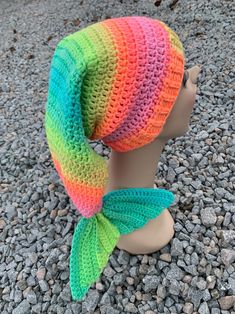 a crocheted hat with a fish tail on top of a mannequin head