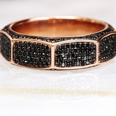 OM Pav'e– a men's ring that embodies strength and sophistication. Crafted in luxurious rose gold, this distinguished piece features a total carat weight of 2, composed of meticulously set natural black diamonds. The bold design is accentuated by round accent diamonds, which add a layer of brilliance and depth to the ring. The OM Pav'e ring is designed for the modern man who values both style and substance. The natural black diamonds, with their intense color and captivating allure, make a powerf Black Diamond Ring Men, Diamond Ring Men, Engagement Ring Black Diamond, Diamond Ring Rose Gold, Engagement Ring Black, White Diamond Rings, Black Diamond Necklace, Black Diamond Studs, Black Diamond Jewelry