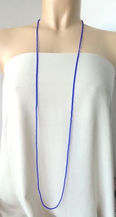 "This is a one strand beaded sapphire blue necklace, with NO CLASP, and can be worn in multiple ways, as shown in pictures. ❤ SIZES This item is one size fits all. ❤ PROCESSING AND SHIPPING Most orders are made and shipped out in one business day. Please check delivery timeframes for your location on the description below. ❤ CUSTOM ORDERS If you like this item in a different color, send me a message indicating: color, size and quantity needed. I will send you a link for a \"custom order\" and yo Blue Round Beads Waist Beads For Gift, Blue Waist Beads Gift, Elegant Blue Beaded Necklace For Beach, Blue Round Beads Necklaces For Summer, Handmade Blue Necklace For Summer, Blue Single Strand Beaded Necklace For Summer, Blue Long Necklace With Colorful Round Beads, Blue Long Necklace With Colorful Beads, Blue Bohemian Long Necklace With Colorful Beads