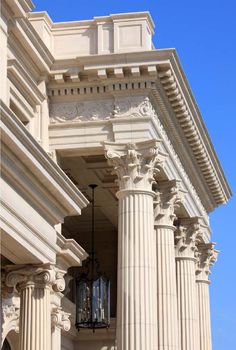 an old building with columns and a clock on the front