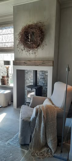 a living room filled with furniture and a fire place next to a wall mounted wood burning stove