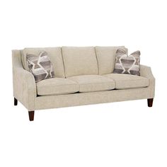 a beige couch with two pillows on it