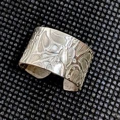 This Handcrafted Ring Is Made From Sterling Silver. It Features An Ivy Vine Design. It Currently Measures A Size 7.5, But Can Be Somewhat Adjustable. The Band Is Wide - About 1cm Wide. Artisan Made In The Usa And Brand New Without Tags. Artisan Open Ring With Polished Finish, Artisan Polished Open Ring Jewelry, Unique Open Band Sterling Silver Jewelry, Artisan Wide Band Jewelry As Gift, Unique Open Band Jewelry With Polished Finish, Unique Wide Band Jewelry For Anniversary, Handmade Open Band Jewelry For Anniversary, Modern Etched Ring Jewelry, Unique Etched Round Jewelry