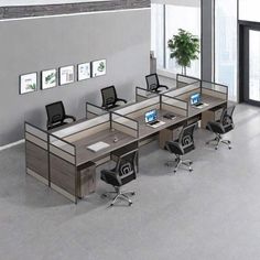 an office cubicle with four desks and chairs