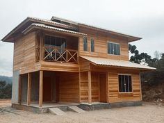 a large wooden building sitting on top of a dirt field