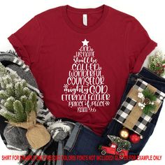 a t - shirt with the words christmas written in white on it, surrounded by other items