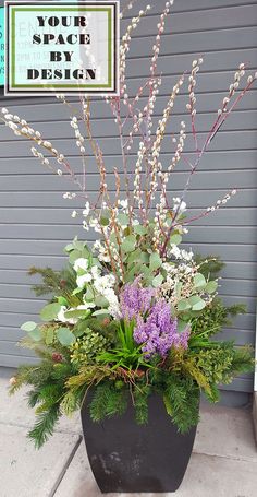 a planter filled with lots of flowers and greenery