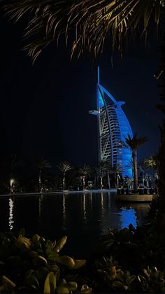 the burj building is lit up at night