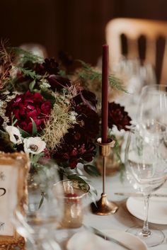 the table is set with flowers and candles