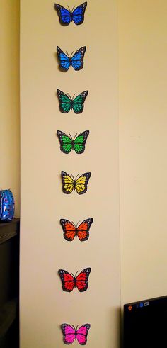 the butterflies are arranged on the wall to look like they're flying in different directions