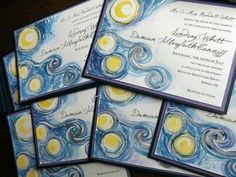 the wedding stationery is decorated with blue, yellow and white swirls on paper