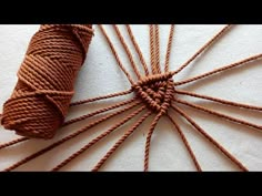 a spool of brown twine sitting on top of a white surface